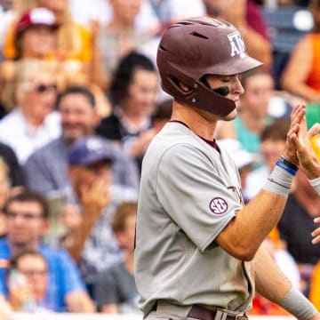 Jun 22, 2024; Omaha, NE, USA; Texas A&M Aggies shortstop Ali Camarillo (2) and left fielder Caden Sorrell (13) celebrate after scoring runs against the Tennessee Volunteers during the third inning at Charles Schwab Field Omaha. Mandatory Credit: Dylan Widger-USA TODAY Sports
