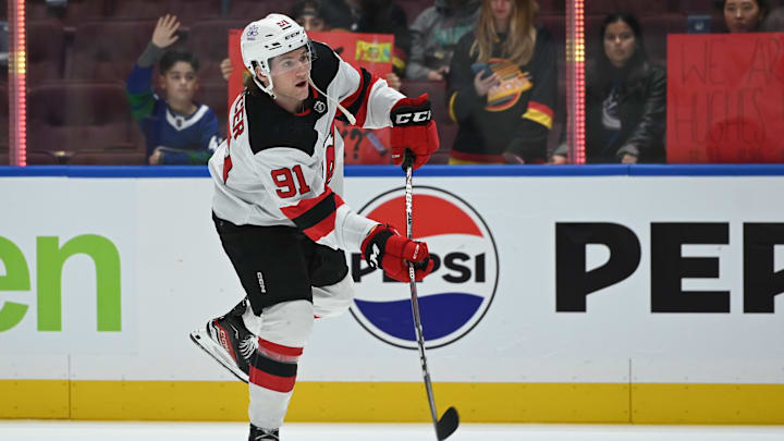 Dec 5, 2023; Vancouver, British Columbia, CAN; New Jersey Devils center Dawson Mercer (91) shoots the puck during the pregame warmup against the Vancouver Canucks at Rogers Arena. Mandatory Credit: Simon Fearn-Imagn Images