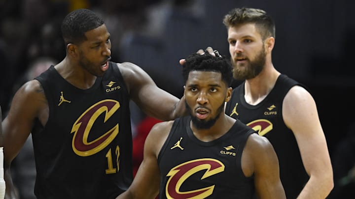 Oct 31, 2023; Cleveland, Ohio, USA; Cleveland Cavaliers center Tristan Thompson (12), guard Donovan Mitchell (45) and forward Dean Wade (32) celebrate in the second quarter against the New York Knicks at Rocket Mortgage FieldHouse. Mandatory Credit: David Richard-Imagn Images