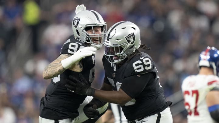 November 5, 2023; Paradise, Nevada, USA; Las Vegas Raiders defensive end Maxx Crosby (98) and defensive tackle Adam Butler (69) celebrate after sacking New York Giants quarterback Tommy DeVito (not pictured) during the third quarter at Allegiant Stadium. Mandatory Credit: Kyle Terada-USA TODAY Sports