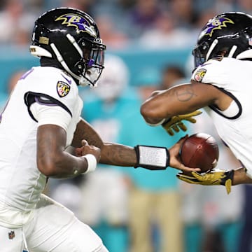 Oct 30, 2025; Miami Gardens, Florida, USA; Baltimore Ravens quarterback Lamar Jackson (8) hands the ball off to Baltimore Ravens running back Derrick Henry (22) during the second quarter against the Miami Dolphins at Hard Rock Stadium. Mandatory Credit: Nathan Ray Seebeck-Imagn Images