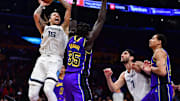 January 20, 2023; Los Angeles, California, USA; Memphis Grizzlies forward Brandon Clarke (15) shoots against Los Angeles Lakers forward Wenyen Gabriel (35) during the second half at Crypto.com Arena. Mandatory Credit: Gary A. Vasquez-Imagn Images