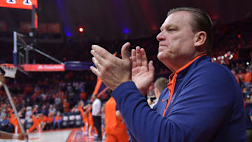 Nov 13, 2024; Champaign, Illinois, USA;  Illinois Fighting Illini head coach Brad Underwood applauds the crowd before a game against the Oakland Golden Grizzlies at State Farm Center. 