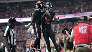Harrison Jr. and Greg Dortch celebrate a touchdown.