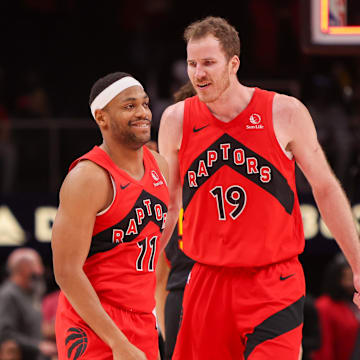 Jan 23, 2025; Atlanta, Georgia, USA; Toronto Raptors forward Bruce Brown (11) and center Jakob Poeltl (19) celebrate after a victory over the Atlanta Hawks at State Farm Arena. Mandatory Credit: Brett Davis-Imagn Images