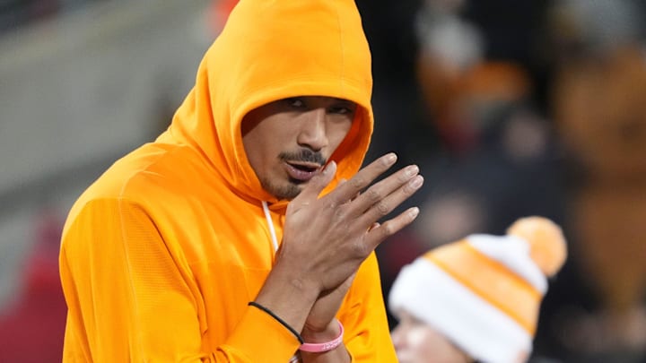 Tennessee quarterback Nico Iamaleava (8) tries to keep warm before the start of the NCAA college football playoff game against Ohio State on Saturday, Dec. 21, 2024, in Columbus, Ohio.