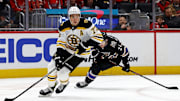 Dec 31, 2024; Washington, District of Columbia, USA; Boston Bruins defenseman Charlie McAvoy (73) skates with the puck against Washington Capitals center Connor McMichael (24) at Capital One Arena. Mandatory Credit: Peter Casey-Imagn Images