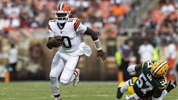 Aug 10, 2024; Cleveland, Ohio, USA; Cleveland Browns quarterback Tyler Huntley (10) runs the ball past Green Bay Packers defensive end Brenton Cox Jr. (57) during the second quarter at Cleveland Browns Stadium. 