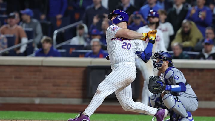 Oct 18, 2024; New York City, New York, USA; New York Mets first base Pete Alonso (20) hits a single in the eighth inning against the Los Angeles Dodgers during game five of the NLCS for the 2024 MLB playoffs at Citi Field. Mandatory Credit: Brad Penner-Imagn Images