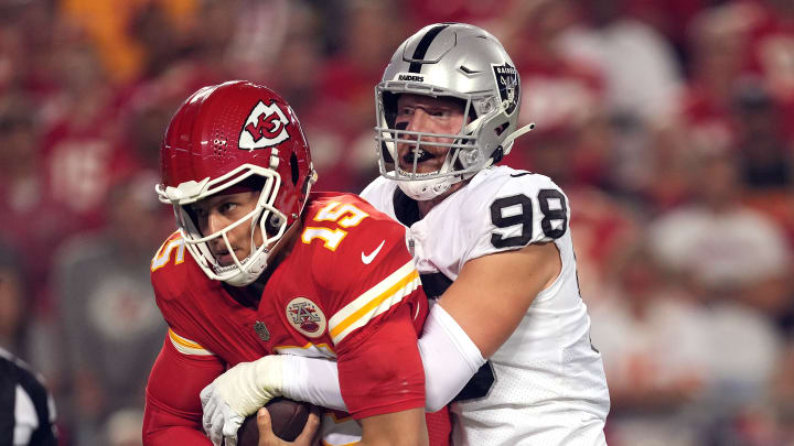 Maxx Crosby tackling Patrick Mahomes.