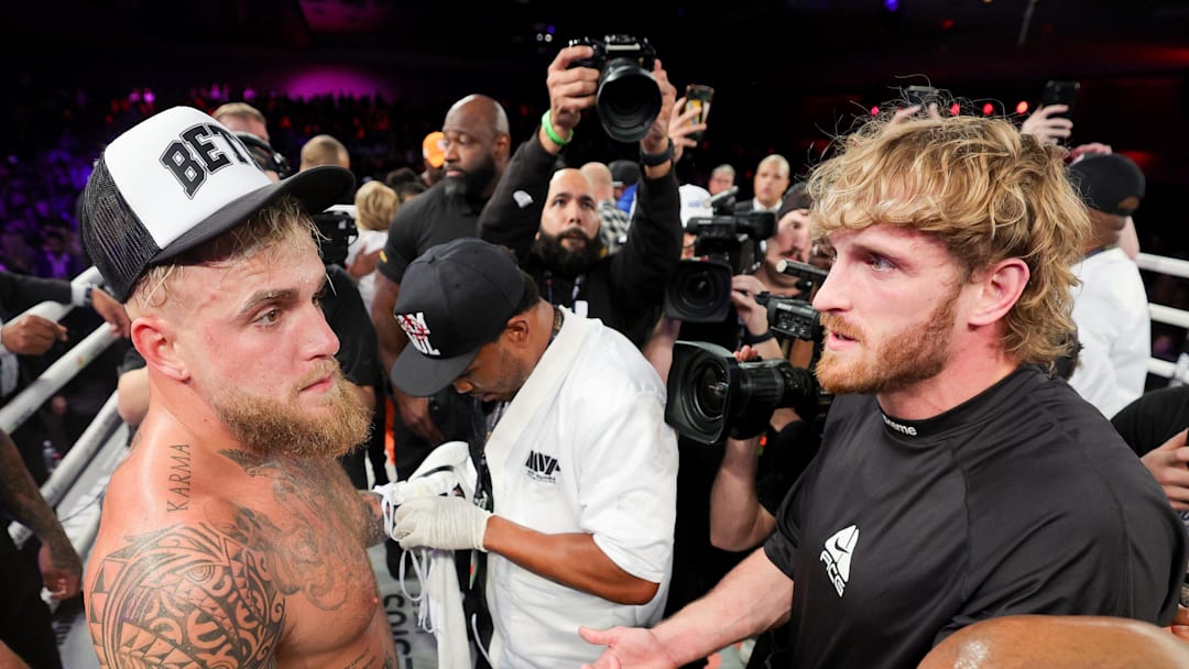Dec 15, 2023; Orlando, Florida, USA;  Jake Paul is congratulated by Logan Paul after knocking out Andre August in the first round at the Caribe Royale Orlando. Mandatory Credit: Nathan Ray Seebeck-Imagn Images