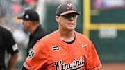 Virginia Cavaliers coach Brian O'Connor leaves the meeting with the umpires before the game against the Florida Gators at Charles Schwab Field Omaha at the College World Series.