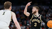 Purdue Boilermakers guard Braden Smith (3) is defended by Michigan Wolverines center Danny Wolf (1) Friday, March 14, 2025, during the Big Ten Men’s Basketball Tournament game at Gainbridge Fieldhouse in Indianapolis. Michigan Wolverines won 86-68.