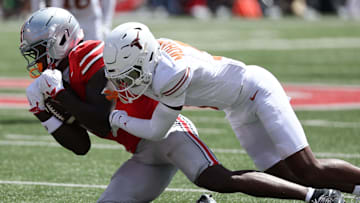 Aug 30, 2025; Columbus, Ohio, USA; Ohio State Buckeyes wide receiver Jeremiah Smith (4) makes a catch over Texas Longhorns defensive back Malik Muhammad (5) in the first half at Ohio Stadium. Mandatory Credit: Joseph Maiorana-Imagn Images