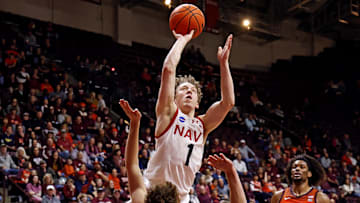 Dec 15, 2024; Blacksburg, Virginia, USA; Navy Midshipmen guard Austin Benigni (1) shoots the ball against Virginia Tech Hokies guard Jaden Schutt (2) during the second half at Cassell Coliseum. 