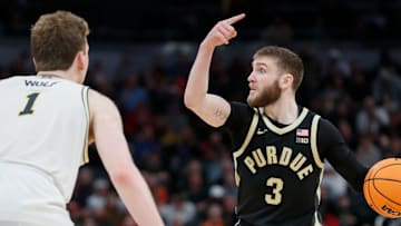 Purdue Boilermakers guard Braden Smith (3) is defended by Michigan Wolverines center Danny Wolf (1) Friday, March 14, 2025, during the Big Ten Men’s Basketball Tournament game at Gainbridge Fieldhouse in Indianapolis. Michigan Wolverines won 86-68.