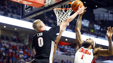 Jan 4, 2025; Oxford, Mississippi, USA; Georgia Bulldogs guard Blue Cain (0) shoots as Mississippi Rebels forward Mikeal Brown-Jones (1) defends during the first half at The Sandy and John Black Pavilion at Ole Miss. Mandatory Credit: Petre Thomas-Imagn Images