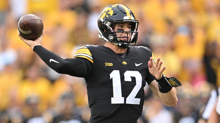 Sep 16, 2023; Iowa City, Iowa, USA;  (12) throws a pass against the Western Michigan Broncos during the fourth quarter at Kinnick Stadium. Mandatory Credit: Jeffrey Becker-USA TODAY Sports