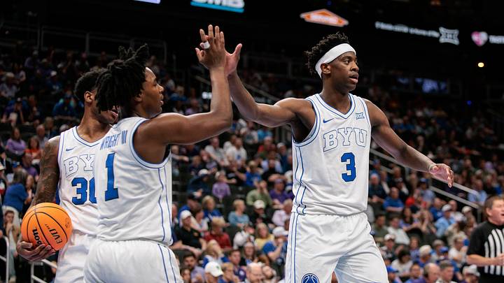 Mar 10, 2026; Kansas City, MO, USA; BYU Cougars forward AJ Dybantsa (3) slaps hands with BYU Cougars guard Robert Wright III (1) after a play during the second half against the Kansas State Wildcats at T-Mobile Center. Mandatory Credit: William Purnell-Imagn Images
