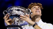 Jannik Sinner poses with the 2025 Australian Open trophy.
