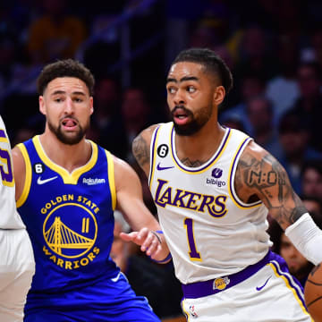 May 6, 2023; Los Angeles, California, USA; Los Angeles Lakers guard D'Angelo Russell (1) moves the ball as guard Austin Reaves (15) provides coverage against Golden State Warriors guard Klay Thompson (11) during the first half in game three of the 2023 NBA playoffs at Crypto.com Arena. Mandatory Credit: Gary A. Vasquez-USA TODAY Sports