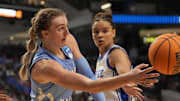Mar 28, 2025; Birmingham, AL, USA; North Carolina Tar Heels forward Alyssa Ustby (1) makes a pass behind Duke Blue Devils forward Delaney Thomas (12) at Legacy Arena. Mandatory Credit: Gary Cosby Jr.-USA Today Network via Imagn Images