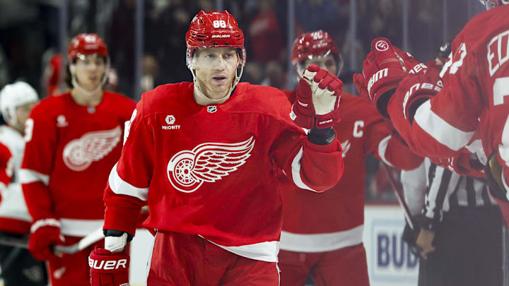 Mar 27, 2025; Detroit, Michigan, USA;  Detroit Red Wings right wing Patrick Kane (88) is congratulated by teammates after scoring in the third period against the Ottawa Senators at Little Caesars Arena. Mandatory Credit: Rick Osentoski-Imagn Images