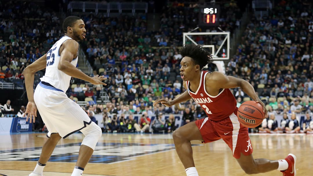 Mar 17, 2018; Pittsburgh, PA, USA;  Alabama Crimson Tide guard Collin Sexton (2) handles the ball against Villanova Wildcats guard Mikal Bridges (25) during the second half in the second round of the 2018 NCAA Tournament at PPG Paints Arena. Villanova won 81-58. Mandatory Credit: Charles LeClaire-Imagn Images
