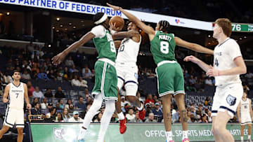 Oct 8, 2025; Memphis, Tennessee, USA; Memphis Grizzlies guard Javon Small (10) drives to the basket as Boston Celtics forward Chris Boucher (99) and forward Josh Minott (8) defend during the third quarter at FedExForum. Mandatory Credit: Petre Thomas-Imagn Images