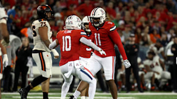 Oct 28, 2023; Tucson, Arizona, USA; Arizona Wildcats linebacker Taylor Upshaw #11 celebrates a tackle for loss with Arizona Wildcats linebacker Justin Flowe #10 during the first half at Arizona Stadium. Mandatory Credit: Zachary BonDurant-Imagn Images