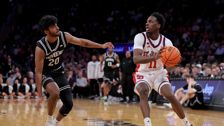 Mar 12, 2026; New York, NY, USA; St. John's basketball guard Ian Jackson (11) controls the ball against Providence Friars guard Nilavan Daniels (20) during the second half at Madison Square Garden.