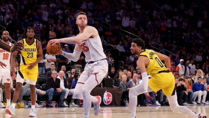 May 19, 2024; New York, New York, USA; New York Knicks center Isaiah Hartenstein (55) looks to pass the ball against Indiana Pacers forward Aaron Nesmith (23) and guard Tyrese Haliburton (0) during the fourth quarter of game seven of the second round of the 2024 NBA playoffs at Madison Square Garden. Mandatory Credit: Brad Penner-USA TODAY Sports