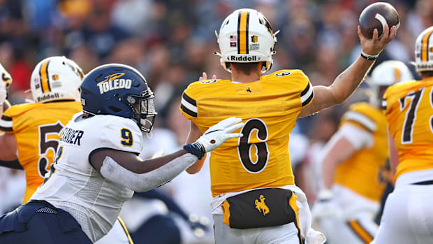 Toledo Rockets defensive tackle Darius Alexander (9) pressures Wyoming quarterback Andrew Peasley (6).
