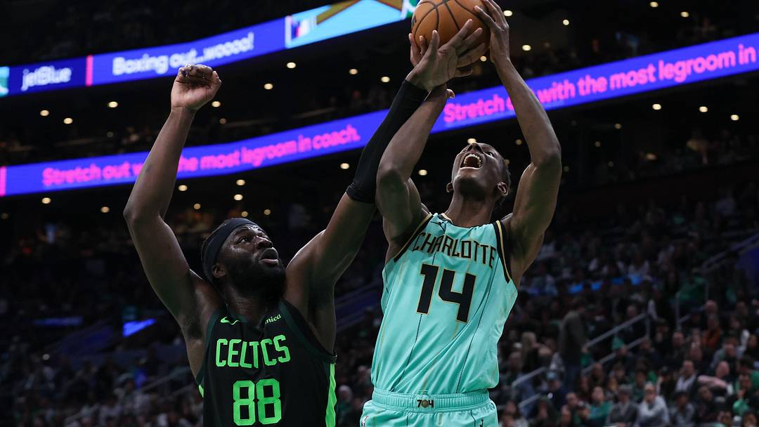 Apr 13, 2025; Boston, Massachusetts, USA; Boston Celtics center Neemias Queta (88) fouls Charlotte Hornets forward Moussa Diabate (14) during the second half at TD Garden. Mandatory Credit: Paul Rutherford-Imagn Images