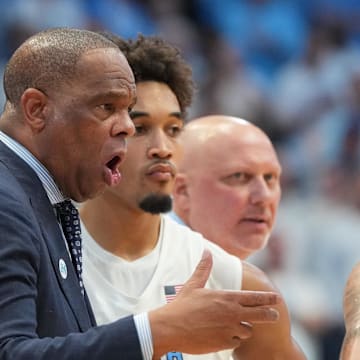 Nov 7, 2025; Chapel Hill, North Carolina, USA; North Carolina Tar Heels head coach Hubert Davis talks with guard Kyan Evans (0) in the second half at Dean E. Smith Center. Mandatory Credit: Bob Donnan-Imagn Images