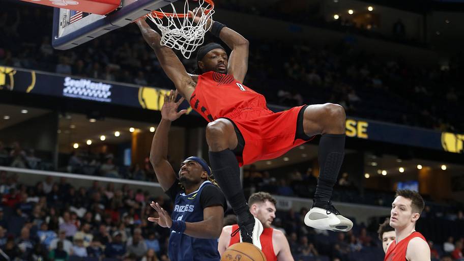 Portland Trail Blazers forward Jerami Grant dunks as Memphis Grizzlies guard Jahmai Mashack defends.
