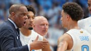 Nov 7, 2025; Chapel Hill, North Carolina, USA; North Carolina Tar Heels head coach Hubert Davis talks with guard Kyan Evans (0) in the second half at Dean E. Smith Center. Mandatory Credit: Bob Donnan-Imagn Images