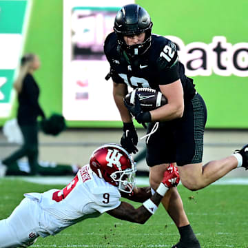 Nov 2, 2024; East Lansing, Michigan, USA;  Michigan State Spartans tight end Jack Velling (12) evades Indiana Hoosiers defensive back Jamier Johnson (9) during the third quarter at Spartan Stadium. Mandatory Credit: Dale Young-Imagn Images