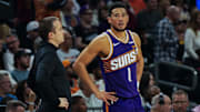 Nov 23, 2025; Phoenix, Arizona, USA: Phoenix Suns Head Coach Jordan Ott and Phoenix Suns guard Devin Booker (1) talk in the first half of the game at Mortgage Match Up Center. Mandatory Credit: Arianna Grainey-Imagn Images