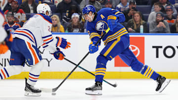 Nov 17, 2025; Buffalo, New York, USA;  Edmonton Oilers defenseman Evan Bouchard (2) tries to block a shot by Buffalo Sabres center Tage Thompson (72) during the second period at KeyBank Center. Mandatory Credit: Timothy T. Ludwig-Imagn Images