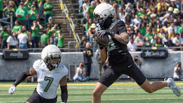 Combat Duck Kyler Kasper, right, pulls down a pass reception ahead of Fighting Duck Ify Obidegwu during the second half.