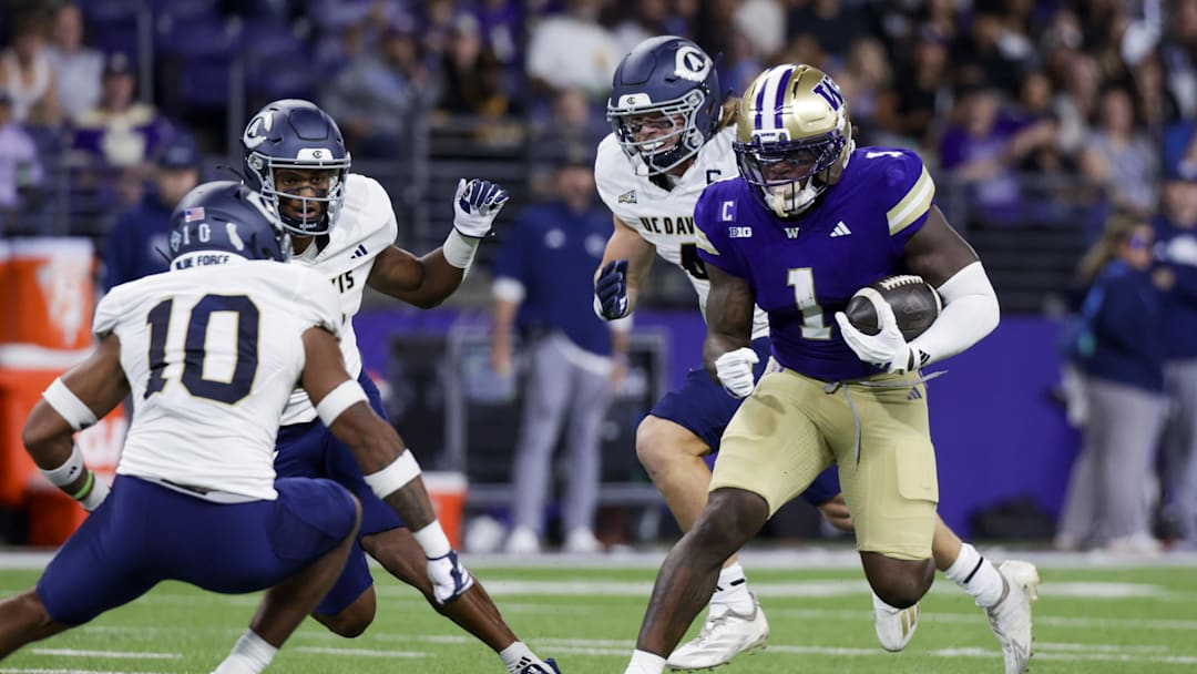 Sep 6, 2025; Seattle, Washington, USA; Washington Huskies running back Jonah Coleman (1) rushes against the UC Davis Aggies during the first quarter at Husky Stadium. Mandatory Credit: Joe Nicholson-Imagn Images