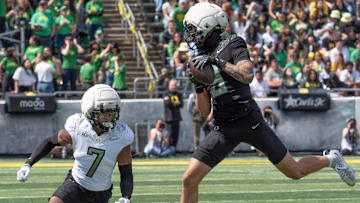 Combat Duck Kyler Kasper, right, pulls down a pass reception ahead of Fighting Duck Ify Obidegwu during the second half.