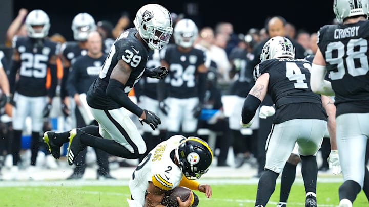 Oct 13, 2024; Paradise, Nevada, USA; Las Vegas Raiders cornerback Nate Hobbs (39) leaps over a sliding Pittsburgh Steelers quarterback Justin Fields (2) during the fourth quarter at Allegiant Stadium. Mandatory Credit: Stephen R. Sylvanie-Imagn Images Oct 13, 2024; Paradise, Nevada, USA; Las Vegas Raiders cornerback Nate Hobbs (39) leaps over a sliding Pittsburgh Steelers quarterback Justin Fields (2) during the fourth quarter at Allegiant Stadium. Mandatory Credit: Stephen R. Sylvanie-Imagn Images