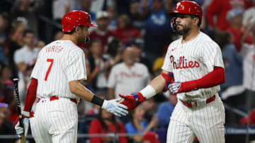 Philadelphia Phillies designated hitter Kyle Schwarber (12) shakes hands with shortstop Trea Turner (7) after hitting a solo home run during the sixth inning against the Tampa Bay Rays at Citizens Bank Park.