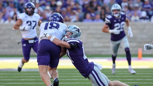TCU Horned Frogs wide receiver Ed Small (18) is tackled by Kansas State Wildcats safety Mikey Bergeron (17) during a kick-off