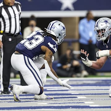 Dallas Cowboys running back Rico Dowdle celebrates with center Brock Hoffman after scoring a touchdown against the Washington Commanders.