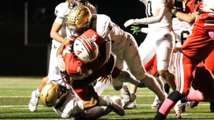 Elizabethtown High School linebacker Darian Bryant tackles John Hardin High School running back Cavalli Pittman Friday, Oct. 24, 2025. 