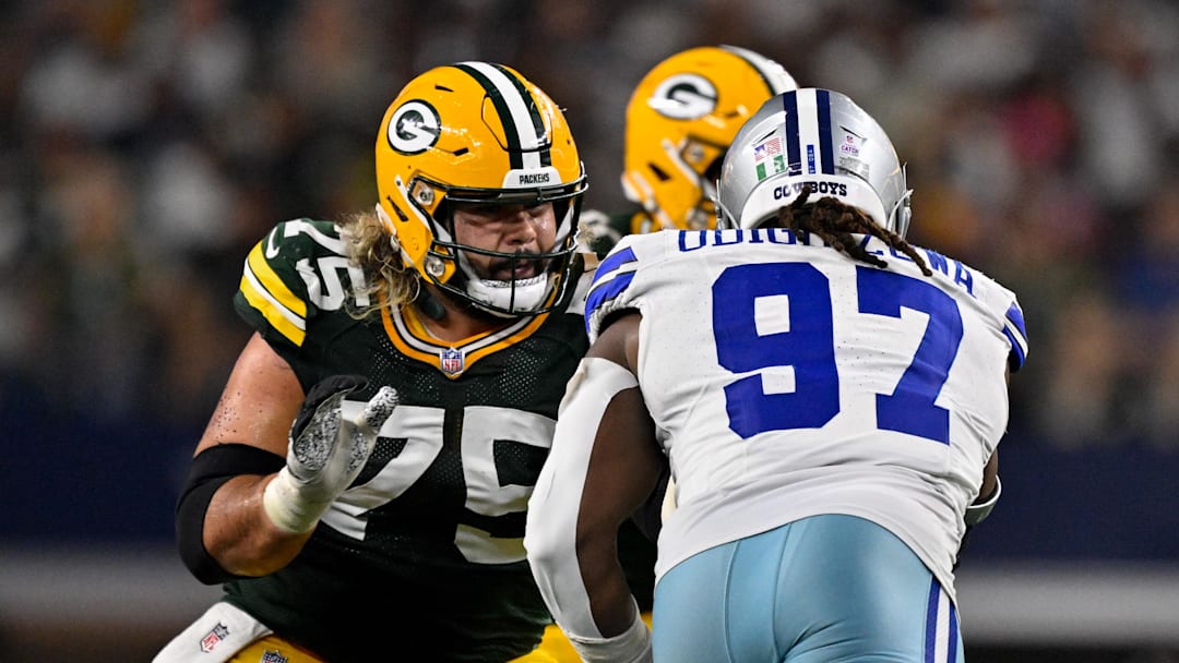 Sep 28, 2025; Arlington, Texas, USA; Green Bay Packers guard Sean Rhyan (75) blocks Dallas Cowboys defensive tackle Osa Odighizuwa (97) during the game between the Dallas Cowboys and the Green Bay Packers at AT&T Stadium. Mandatory Credit: Jerome Miron-Imagn Images