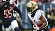 Oct 19, 2025; Chicago, Illinois, USA; New Orleans Saints running back Alvin Kamara (41) rushes the ball against the Chicago Bears during the second half at Soldier Field. Mandatory Credit: Mike Dinovo-Imagn Images